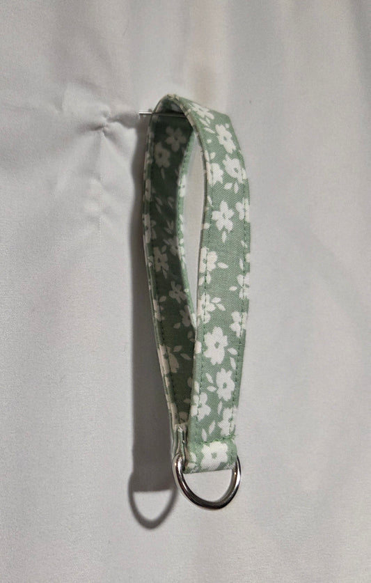 Light green and white floral wristlet